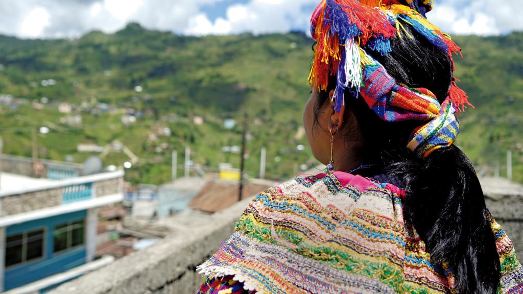 mayan woman overlooking town, in traditional dress